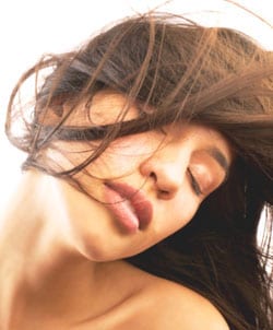 200430201-001 Young woman hair blowing in face, close-up