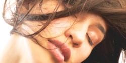 200430201-001 Young woman hair blowing in face, close-up